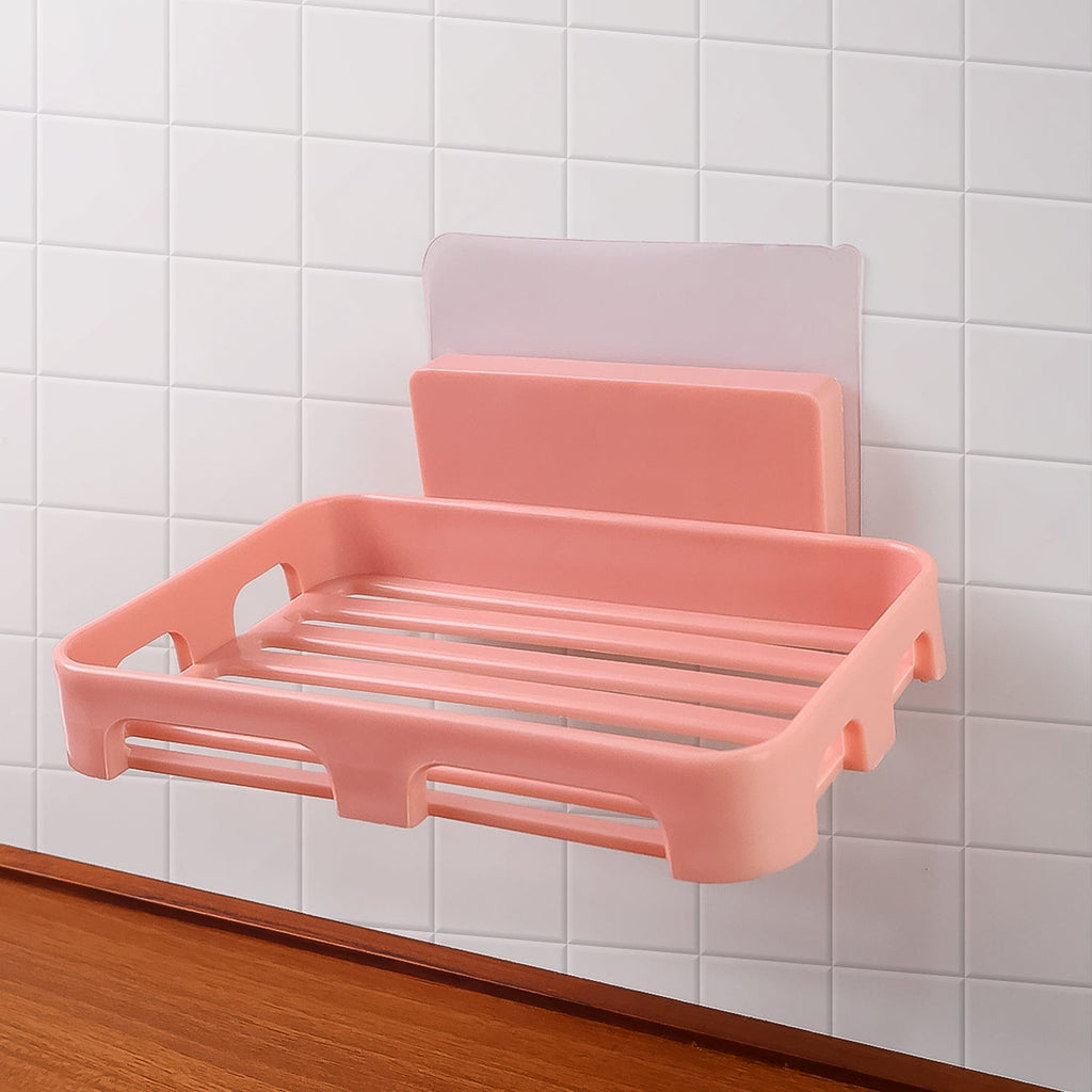 Self adhesive soap dish holder with open slatted design mounted on wall