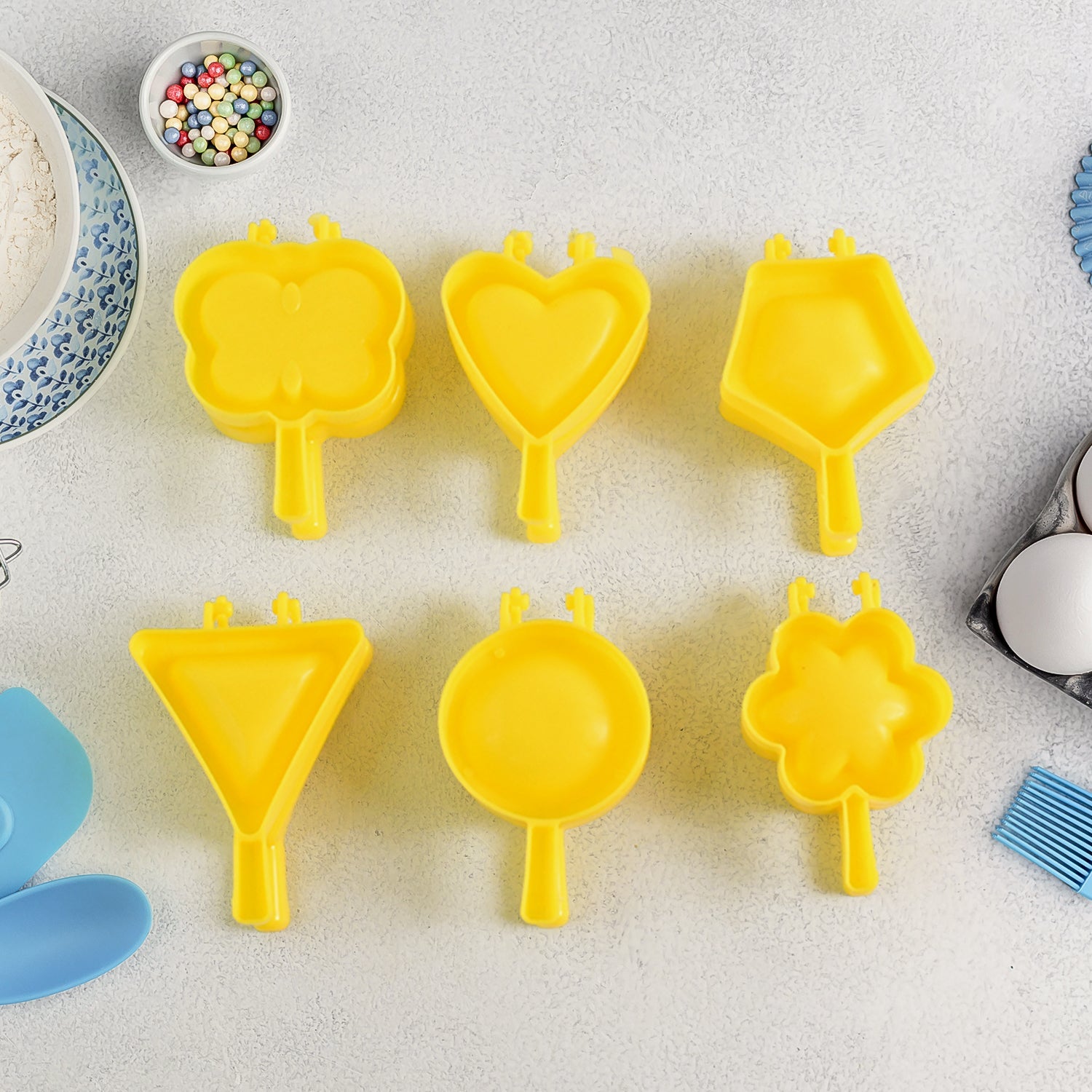 Multi-shape plastic cookie cutter moulds in various bright colours for dough and fondant shaping.