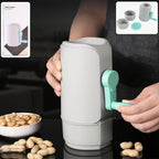 Manual hand-crank peanut sheller machine with a transparent collection tray.