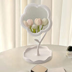 Flower-shaped makeup mirror providing clear reflection with integrated tray for essentials