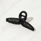 Person styling hair effortlessly with a strong, non-slip hair claw clip