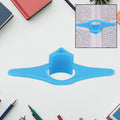 Plastic thumb book support holding a paperback open for easy reading.