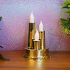 Golden LED flameless candle lamp with triple candle design glowing softly