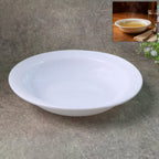 Deep round white curry bowl with glossy finish on white background