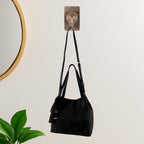 Clear self-adhesive wall hook for compact storage