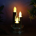 Golden candle lamp with triple LED candles illuminating festive space