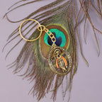 Hand holding Lord Krishna metal keychain showing its size and detail