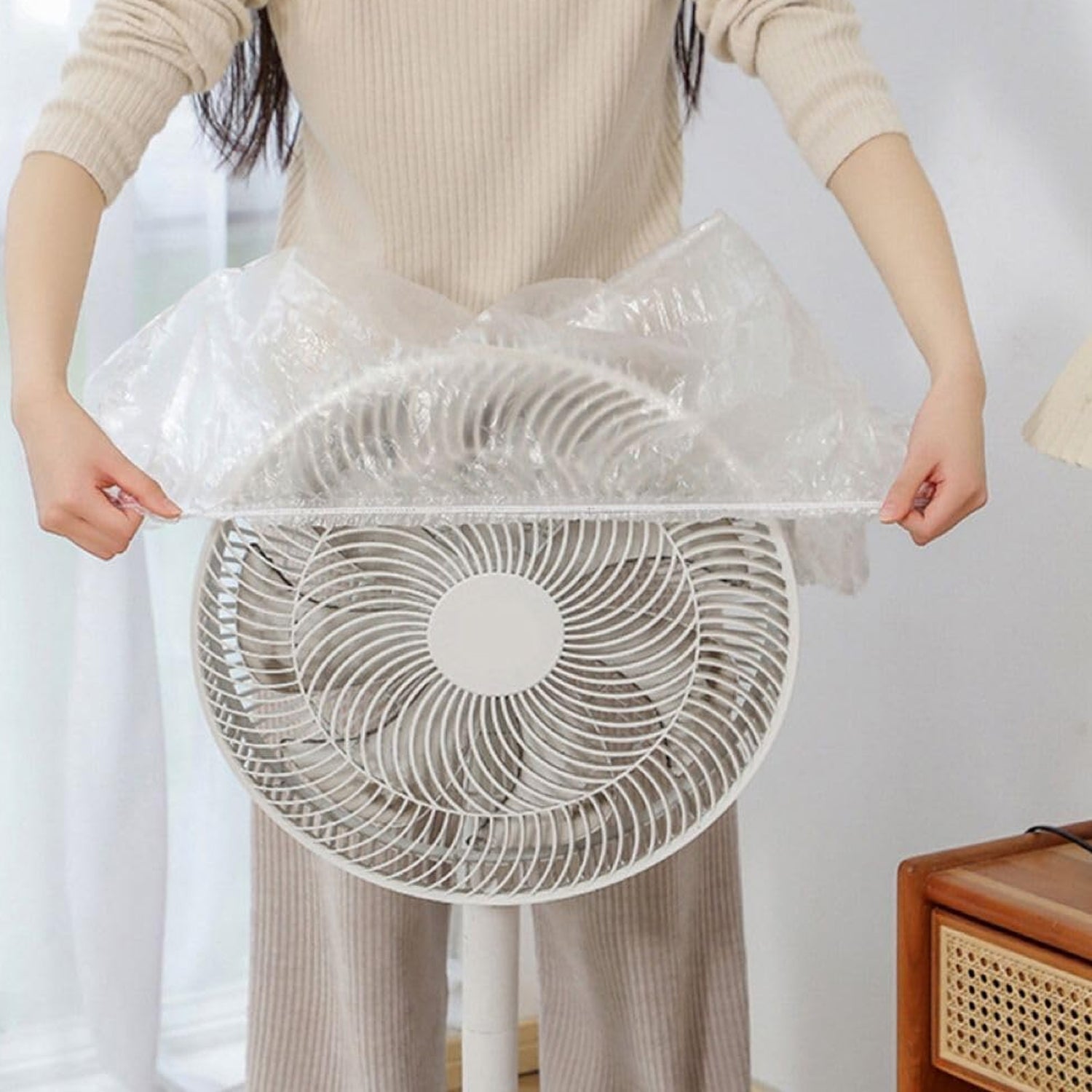 Individual plastic covers protecting dining chairs from dust.