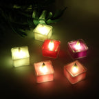 Set of multicolor LED flameless tealight candles glowing warmly