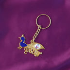 Gold-tone Krishna metal keychain displayed on white background