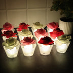Set of Rose Shaped Flameless LED Candles glowing softly with glass holders