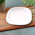 White square plastic dinner plate with rounded edges and glossy surface