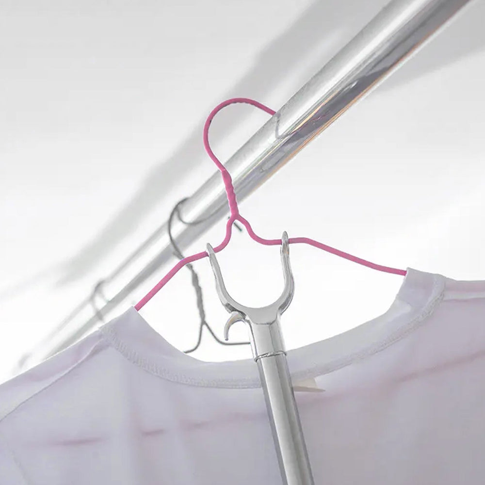 Collapsible garment hanging stick demonstrating its compact storage feature.