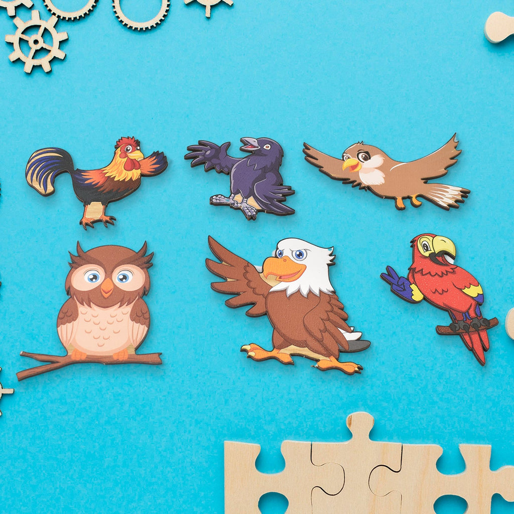 Detailed view of the various wooden bird-shaped puzzle pieces from the educational board.