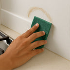 Heavy-duty kitchen scrubber pad cleaning baked-on grease from cookware