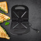 Sandwich toaster showing indicator lights to signal cooking status