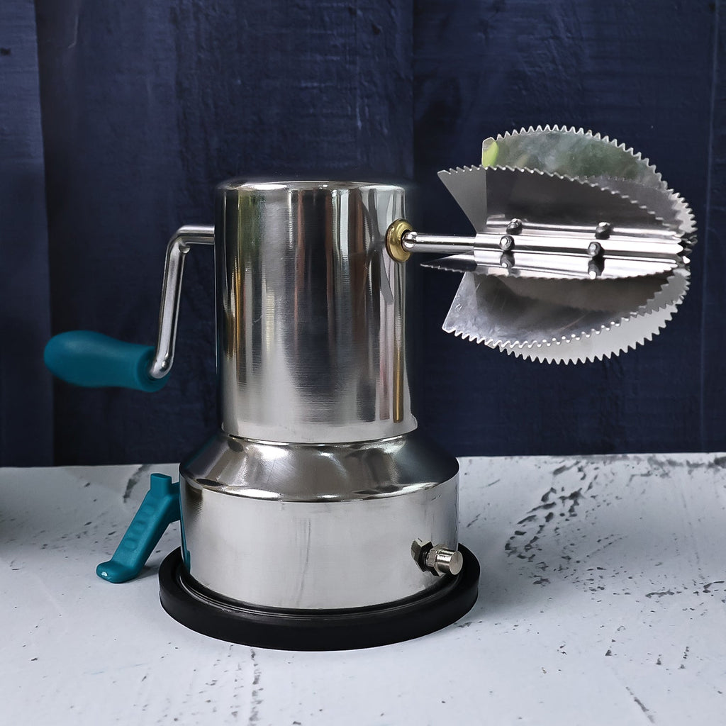 Close-up view of sharp stainless steel blades on the coconut scraper