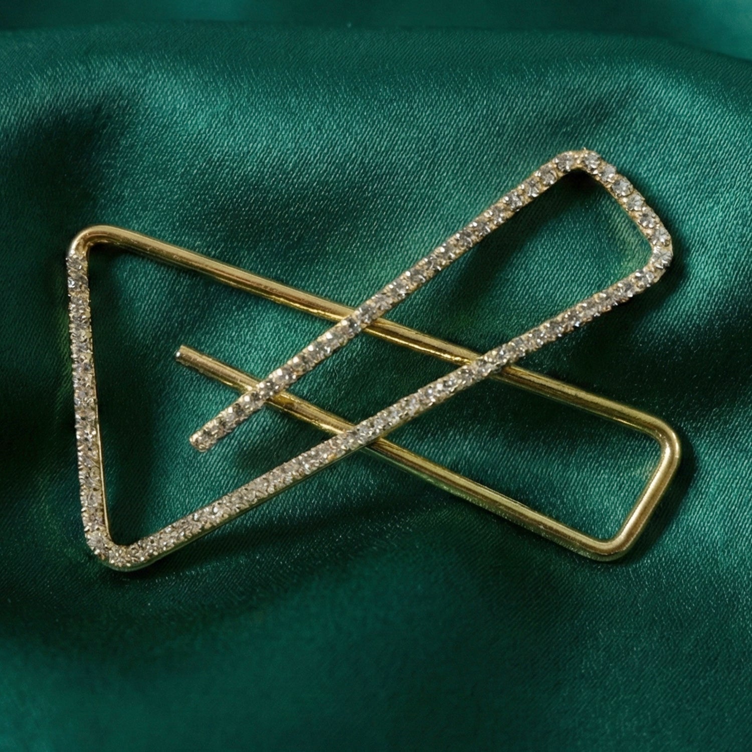 Crystal embellished golden brooch pin securing saree pleats