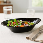 Side view of black plastic Marin serving bowl showcasing depth and oval design