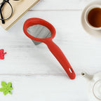 Green tea strainer featuring fine mesh and red plastic handle