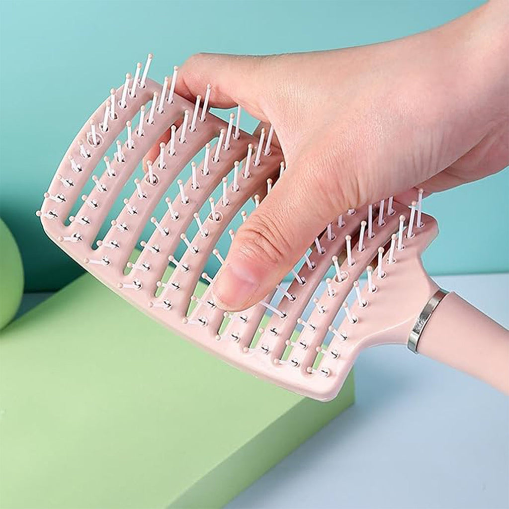 Massage hair comb held by hand showing anti-slip handle for comfortable styling