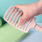 Massage hair comb held by hand showing anti-slip handle for comfortable styling