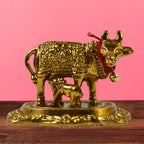 Sacred metal Kamdhenu Cow and calf idol in golden finish