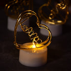 A close-up view of three glowing multicolor flameless heart candles, showcasing their realistic flickering effect.