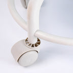 Side view of low rolling stool showing cushioned seat and sturdy wheels