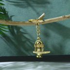 Intricate details of the golden Shivling metal keychain emphasizing religious symbolism