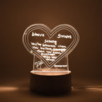 Workspace decorated with glowing 3D acrylic visualization lamp and drawing