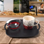 Serving table setup featuring ceramic cups and glass bowls