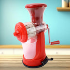 Grippy manual juicer actively pressing an orange to extract fresh juice.