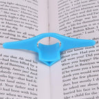 Person comfortably reading a book held open by the plastic thumb page holder.