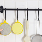 Close-up image of double-sided kitchen cleaning dishwashing sponge brush
