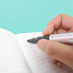 A hand demonstrating the comfortable grip of a black marker, emphasizing its ergonomic design.