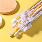 Single soft plastic toothbrush held, demonstrating its comfortable grip and flexible design.