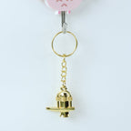 Golden Shivling metal keychain resting on a flat surface highlighting golden finish
