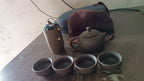 Tea set with teapot, cups & accessories on a wooden tray for travel or home