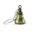 Assortment of metal temple bell keychains in various finishes, highlighting their charm.