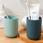 Multipurpose wall mount holder neatly storing toothbrushes, toothpaste, and cups, enhancing bathroom organization.