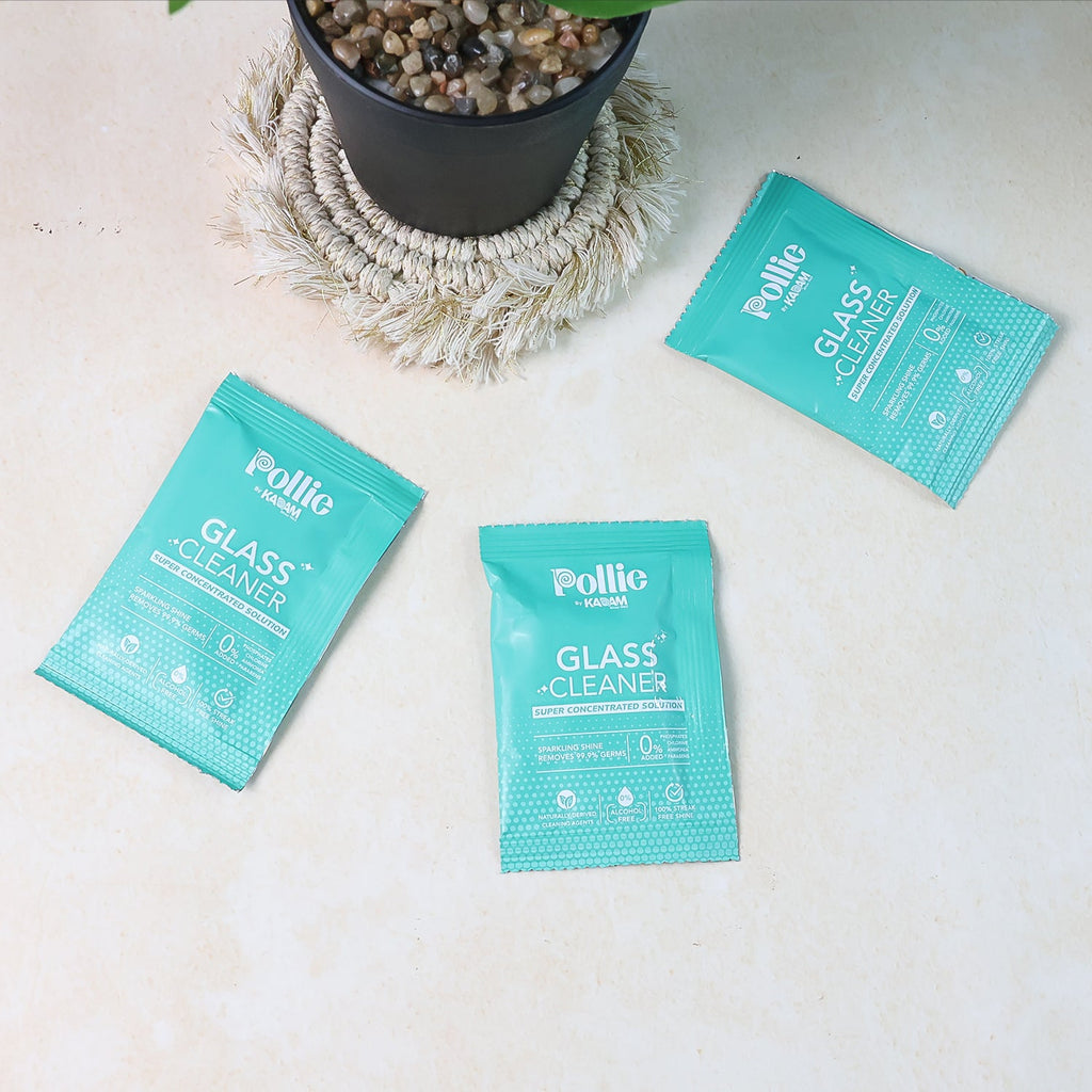 Reusable spray bottle filled with glass cleaner solution from concentrated sachets.