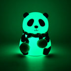Side view of the charming panda night light, showcasing its smooth silicone texture.