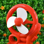 Red portable desk fan, showcasing its compact size and modern aesthetic.