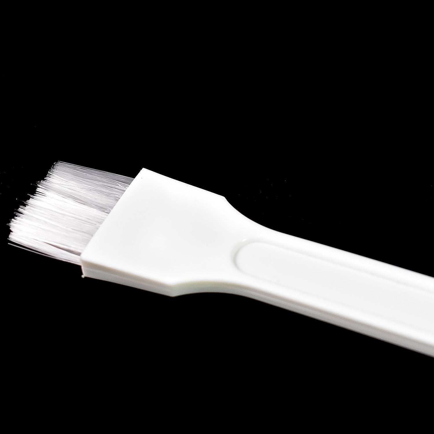 Kitchen cleaning brush reaching into narrow corners.