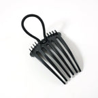 Hair styling comb clip securing hair in a voluminous bun style