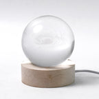 Hand holding the crystal sphere of the 3D Crystal Ball Lamp highlighting craftsmanship.
