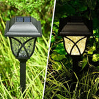 A pair of FitFuzion solar pathway lights installed in a lush green garden, showcasing their elegant design.