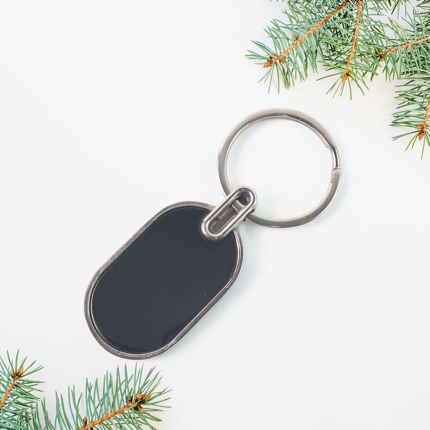 Elegant oval keychain accessory in black and silver tones