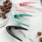 Nutcracker tool made of stainless steel and plastic for cracking hard nuts and shells.